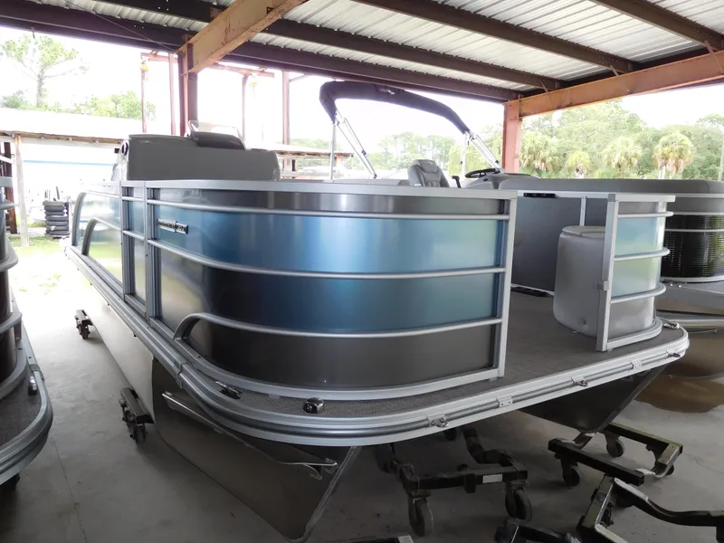 The Image of 2023 SunCatcher 20 Fish pontoon boat in a covered storage area. - 1