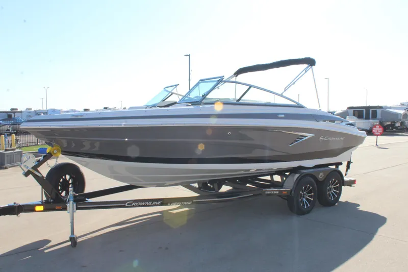 Slide: The Image of 2023 Crownline 220SS boat on trailer, sleek design, outdoor setting. - 10