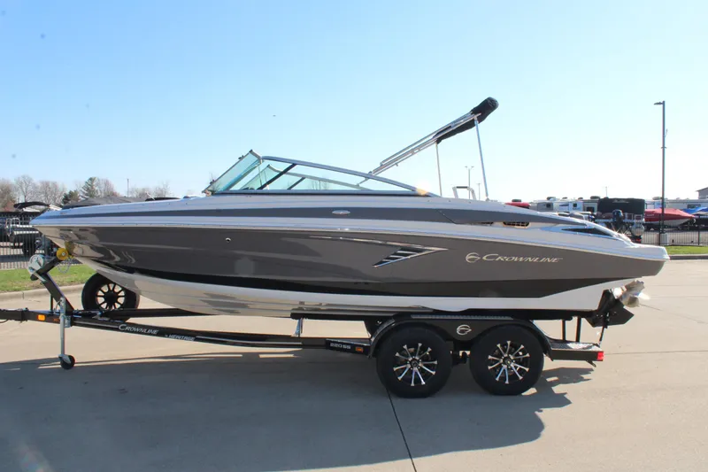 Slide: The Image of 2023 Crownline 220SS boat on trailer, sleek design, parked outdoors. - 11
