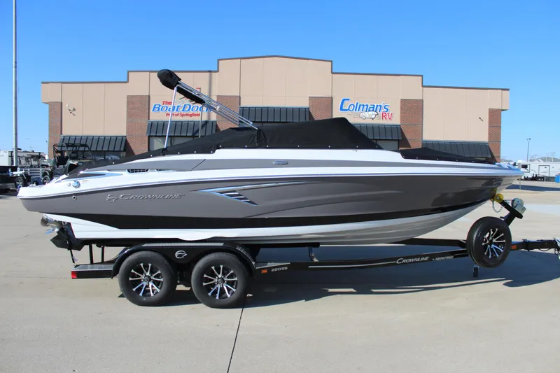 Slide: The Image of 2023 Crownline 220SS boat on trailer in front of dealership. - 12