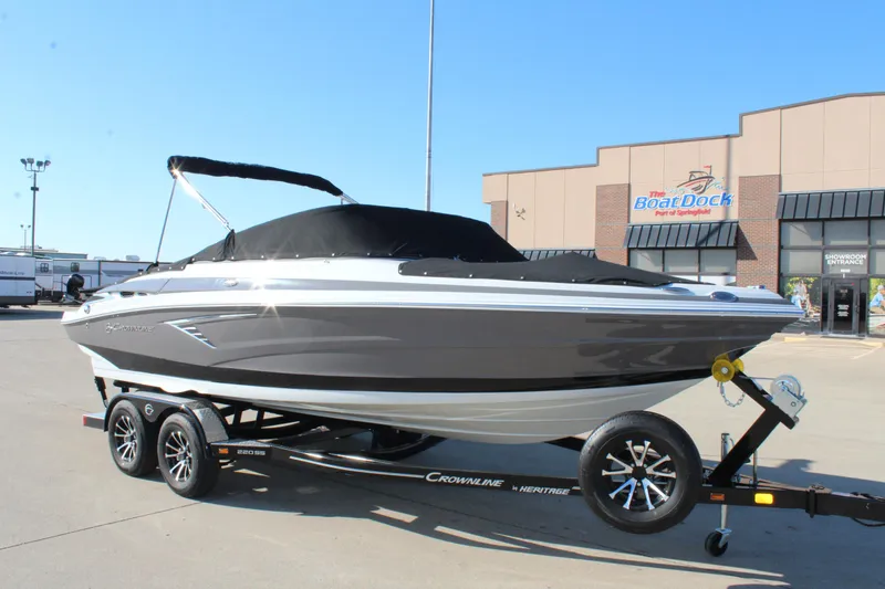 Slide: The Image of 2023 Crownline 220SS boat on trailer at dealership. - 13