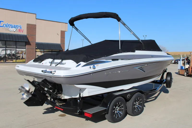 Slide: The Image of 2023 Crownline 220SS boat on trailer, parked outside dealership. - 14