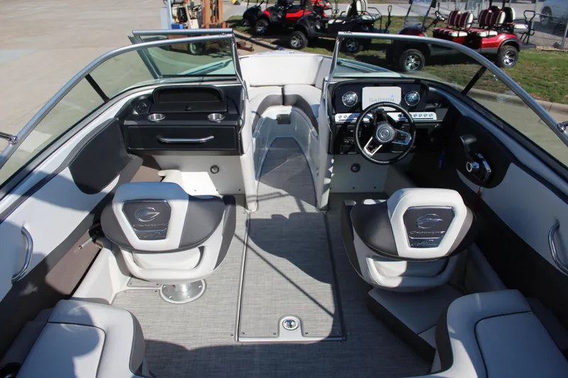 Slide: The Image of 2023 Crownline 220SS boat interior with modern dashboard and seating. - 2