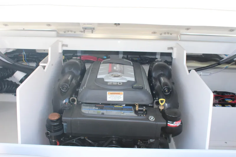 Slide: The Image of 2023 Crownline 220SS boat engine compartment with visible components. - 3