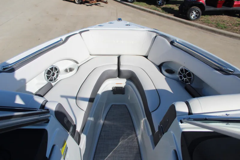 Slide: The Image of 2023 Crownline 220SS boat interior with cushioned seating and speakers. - 4