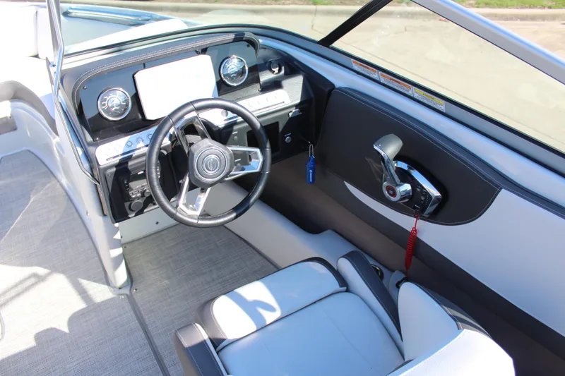 Slide: The Image of 2023 Crownline 220SS boat interior with modern dashboard and steering wheel. - 5