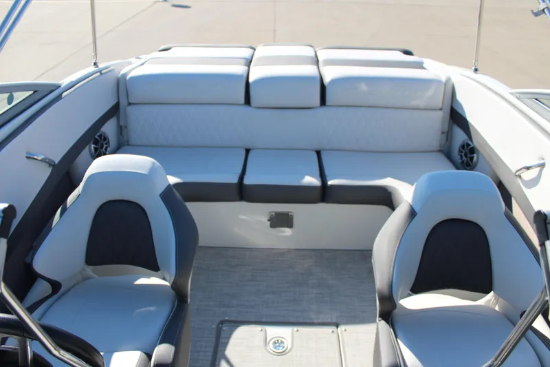 Slide: The Image of 2023 Crownline 220SS boat interior with plush seating and modern design. - 7