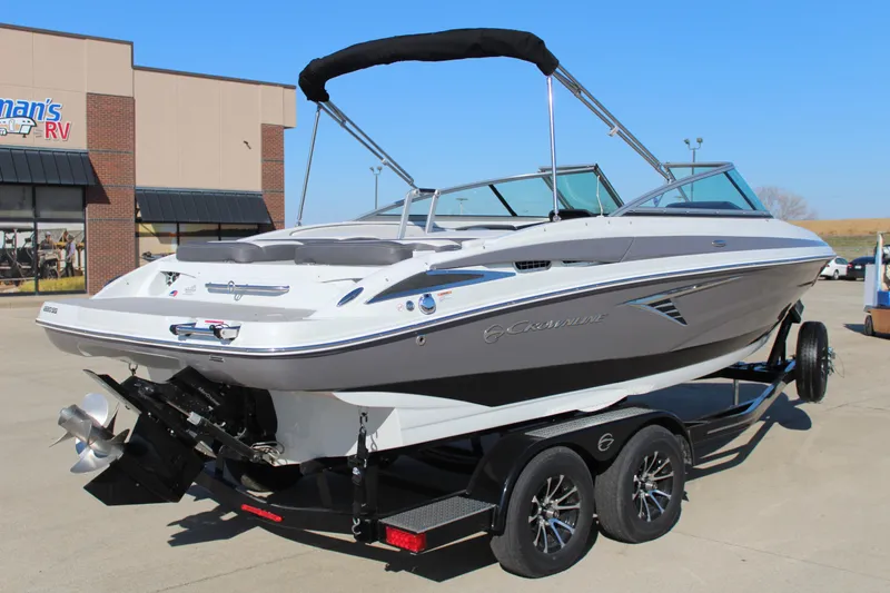 Slide: The Image of 2023 Crownline 220SS boat on trailer, parked outside dealership. - 9