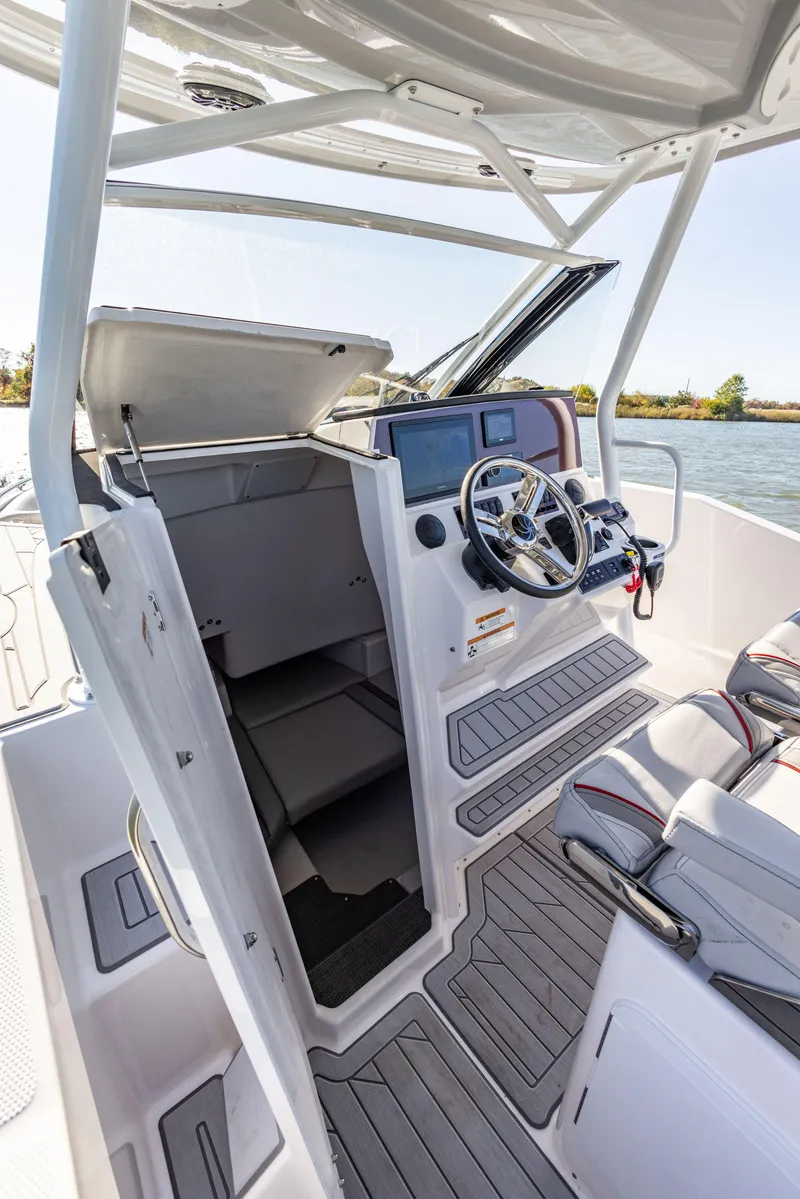 Slide: The Image of 2023 Solara S-250 CW boat interior with steering wheel and seating. - 26