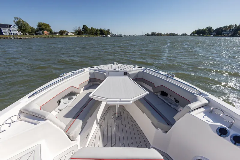 Slide: The Image of 2023 Solara S-250 CW boat with spacious seating and table on a calm lake. - 38