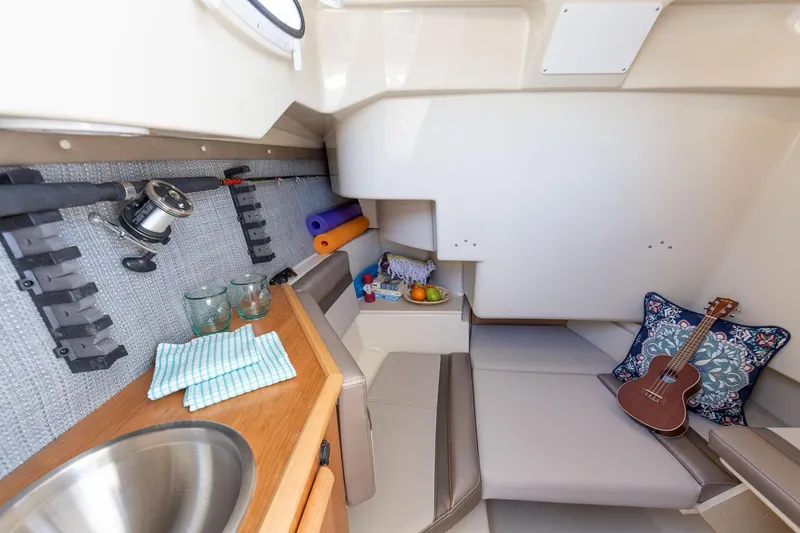 Slide: The Image of Interior cabin of 2023 Solara S-250 CW boat with seating, sink, and storage. - 43