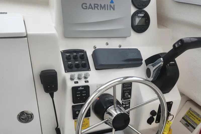 Slide: The Image of 2019 NorthCoast 215 HT boat dashboard with Garmin navigation system and steering wheel. - 14