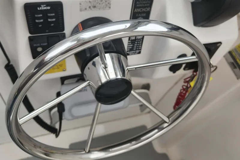 Slide: The Image of Steering wheel of a 2019 NorthCoast 215 HT boat, featuring control panel details. - 15