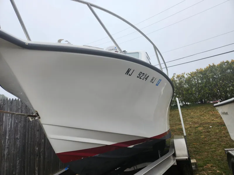 Slide: The Image of 2019 NorthCoast 215 HT boat on trailer, side view with registration number visible. - 18