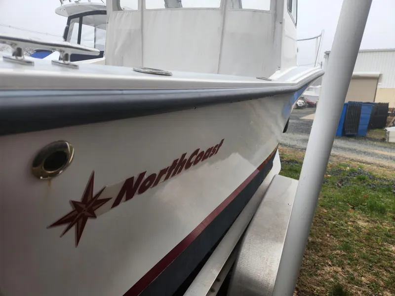 Slide: The Image of 2019 NorthCoast 215 HT boat side view, showcasing sleek design and branding. - 20