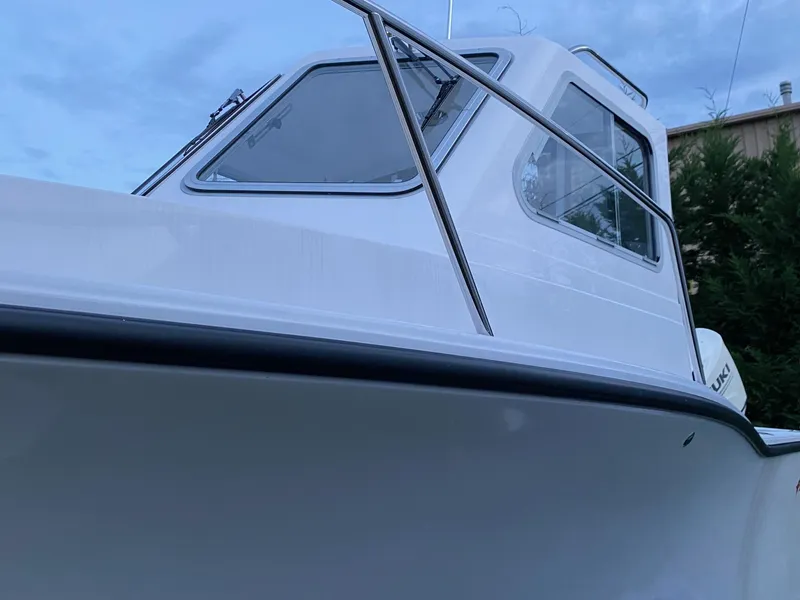 Slide: The Image of 2019 NorthCoast 215 HT boat, white exterior, side view with windows and railing. - 4