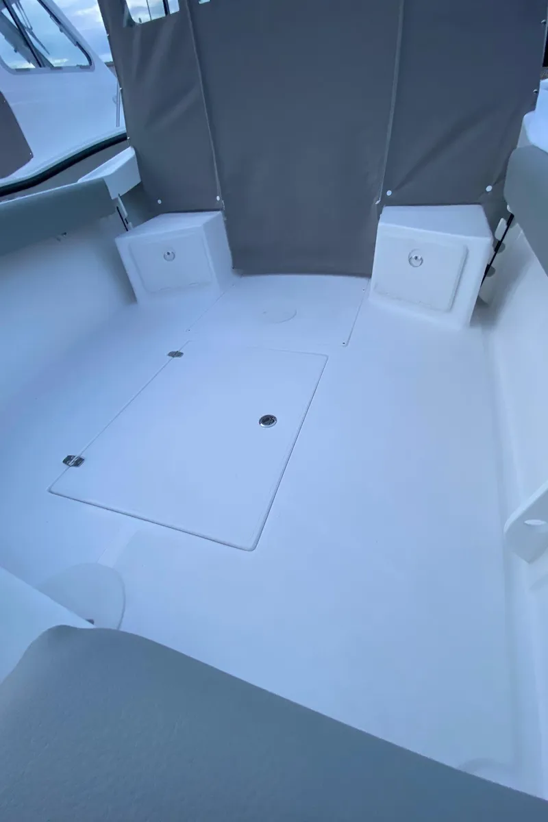 Slide: The Image of 2019 NorthCoast 215 HT boat interior with seating and storage compartments. - 6