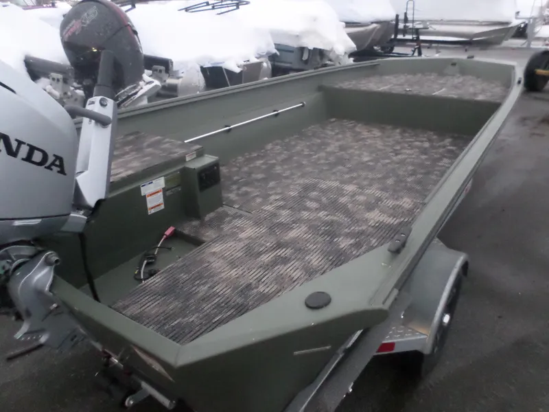 Slide: The Image of 2023 Polar Kraft SMMV 1860 T boat with Honda motor, parked on trailer. - 3