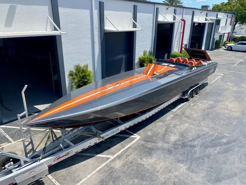 Slide: The Image of 2023 Cigarette 515 powerboat on a trailer outside a warehouse. - 3