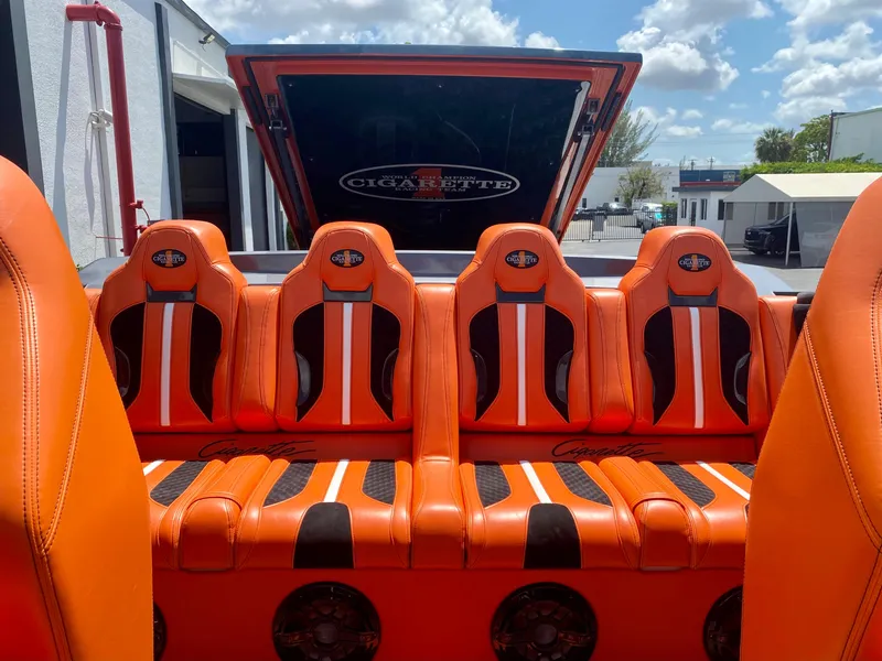 Slide: The Image of Orange and black seats in a 2023 Cigarette 515 boat under a sunny sky. - 5