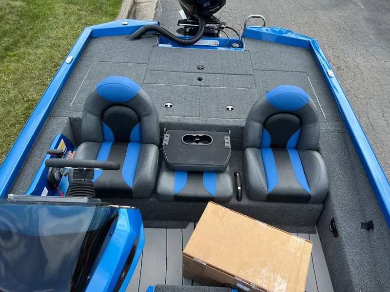 Slide: The Image of 2023 Vexus AVX1980 boat interior with blue and gray seats and a cardboard box. - 14