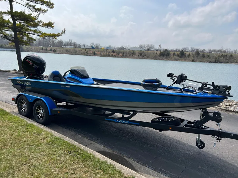 Slide: The Image of 2023 Vexus AVX1980 boat on trailer by a lake. - 2