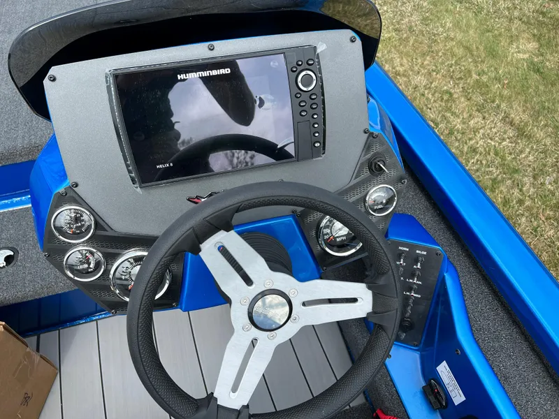 Slide: The Image of 2023 Vexus AVX1980 boat dashboard with Humminbird electronics and steering wheel. - 9