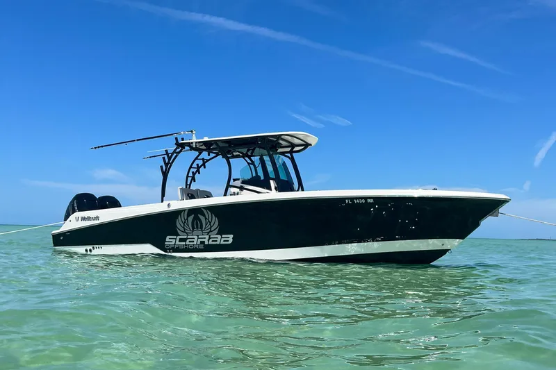 The Image of 2018 Wellcraft 302 Fisherman boat on clear water under blue sky. - 0