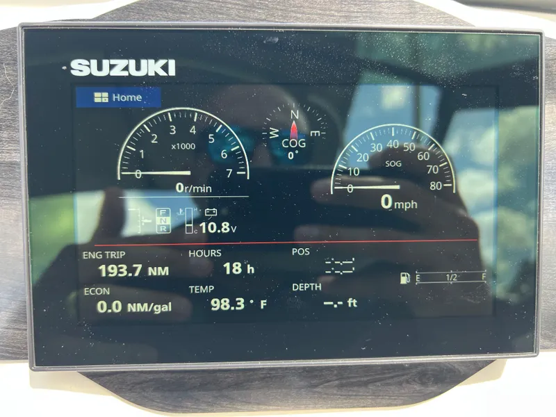Slide: The Image of Suzuki engine display on a 2021 Stingray 191 DC boat showing various metrics. - 14