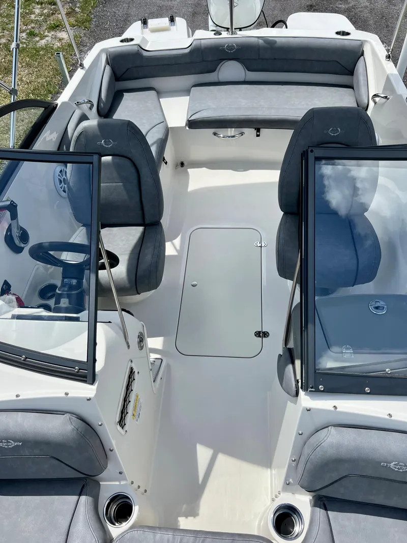 Slide: The Image of 2021 Stingray 191 DC boat interior with gray seating and open cockpit. - 21