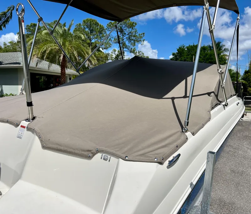 Slide: The Image of 2021 Stingray 191 DC boat with protective cover in a sunny driveway. - 27