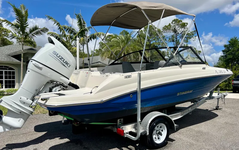 Slide: The Image of 2021 Stingray 191 DC boat with Suzuki outboard motor on trailer. - 7