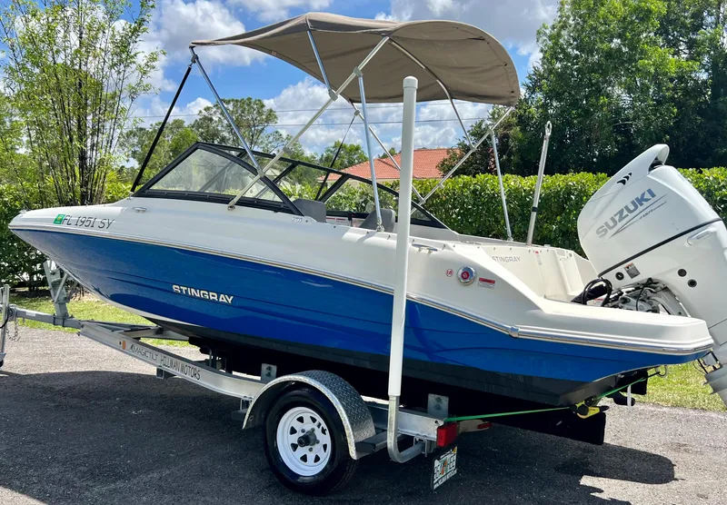 Slide: The Image of 2021 Stingray 191 DC boat on trailer with Suzuki outboard motor. - 9