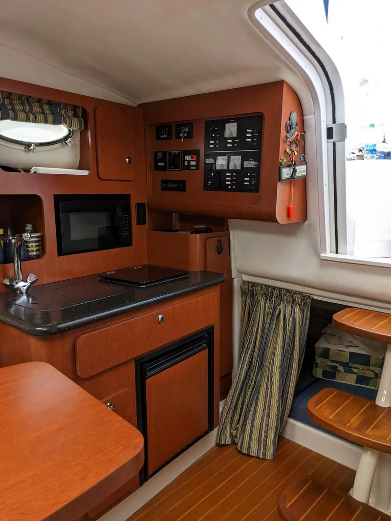 Slide: The Image of 2008 Pro-Line 32 Express cabin interior with kitchenette and control panel. - 11