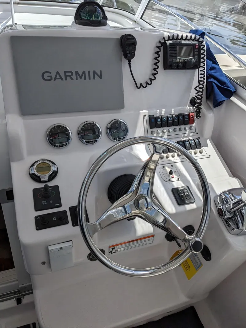 Slide: The Image of 2008 Pro-Line 32 Express boat helm with Garmin navigation and control panel. - 12
