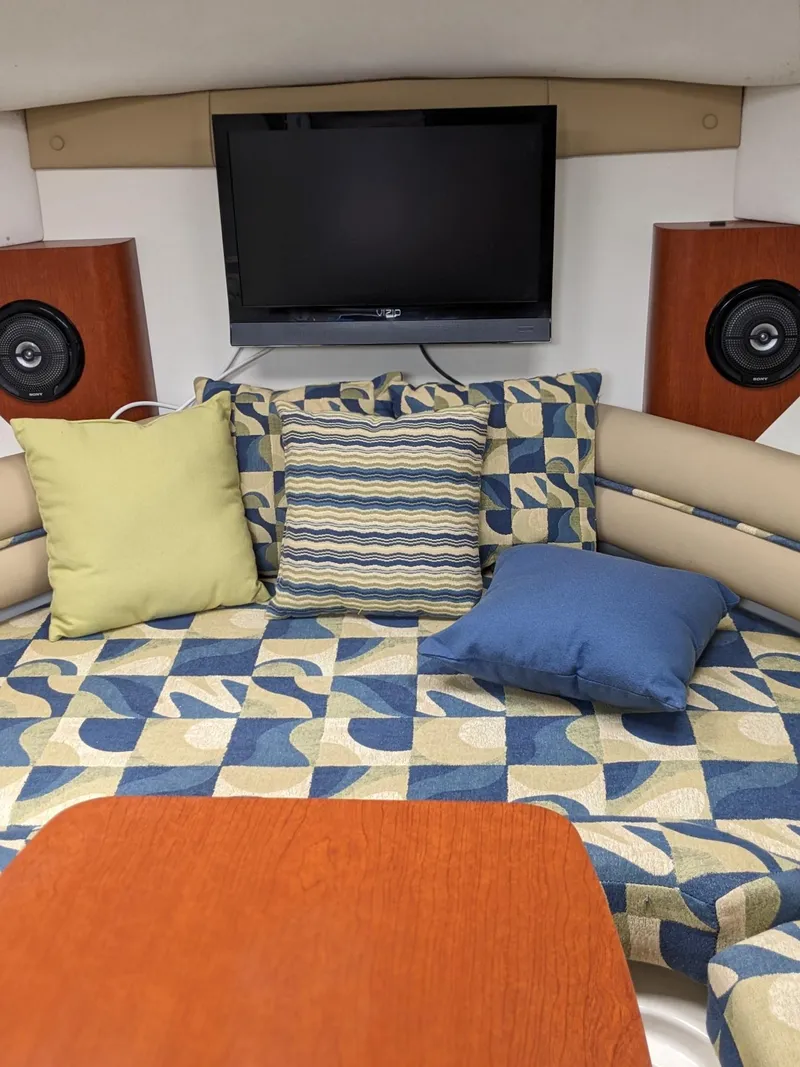 Slide: The Image of Interior of 2008 Pro-Line 32 Express with patterned cushions, pillows, and mounted TV. - 15
