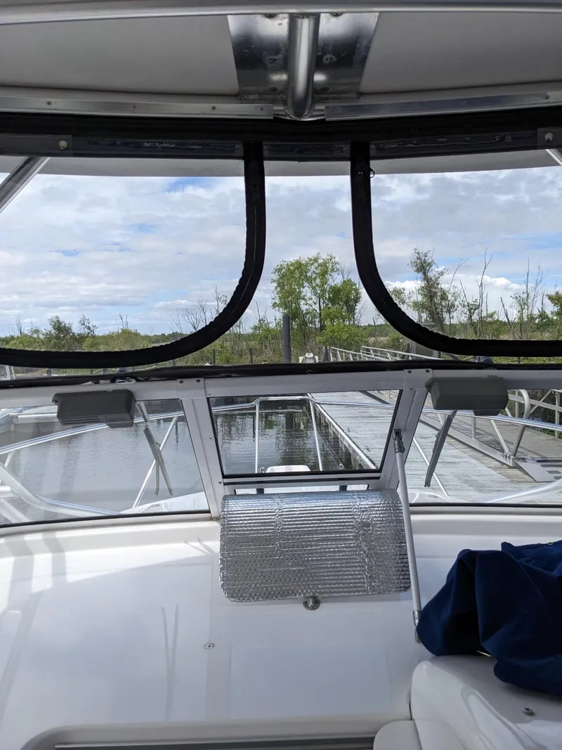 Slide: The Image of 2008 Pro-Line 32 Express boat interior with view of dock and trees. - 16