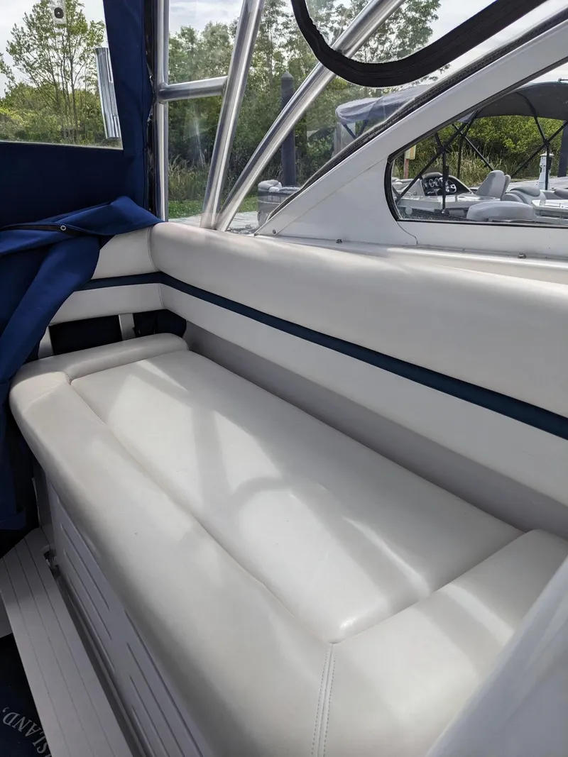 Slide: The Image of 2008 Pro-Line 32 Express boat interior with white seating and blue accents. - 18