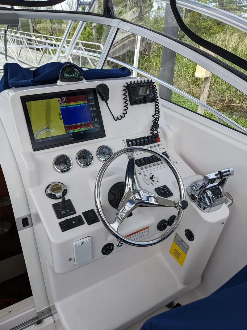 Slide: The Image of 2008 Pro-Line 32 Express boat helm with navigation instruments and steering wheel. - 20