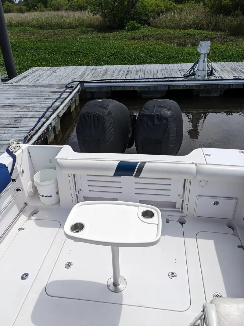 Slide: The Image of 2008 Pro-Line 32 Express boat with dual engines docked at a wooden pier. - 21