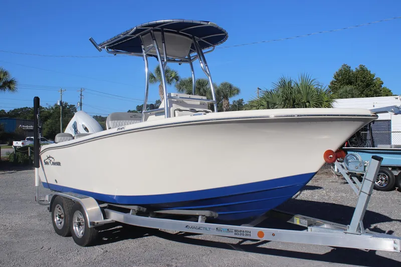 The Image of 2023 Sea Chaser 20 HFC boat on trailer, featuring sleek design and blue hull. - 0