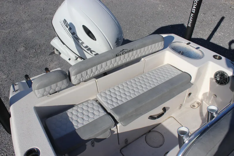 Slide: The Image of 2023 Sea Chaser 20 HFC boat interior with cushioned seating and Suzuki outboard motor. - 10