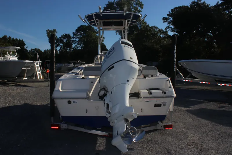 Slide: The Image of 2023 Sea Chaser 20 HFC boat with outboard motor, parked on a trailer. - 2