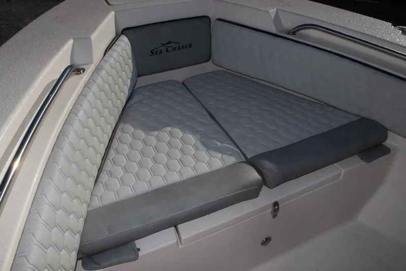 Slide: The Image of 2023 Sea Chaser 20 HFC boat interior with cushioned seating and stainless steel railings. - 6