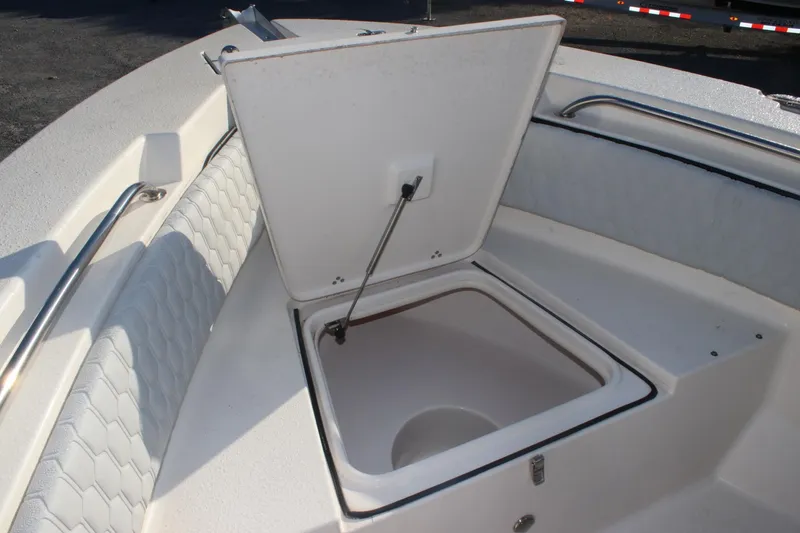 Slide: The Image of 2023 Sea Chaser 20 HFC boat with open storage compartment and cushioned seating. - 7