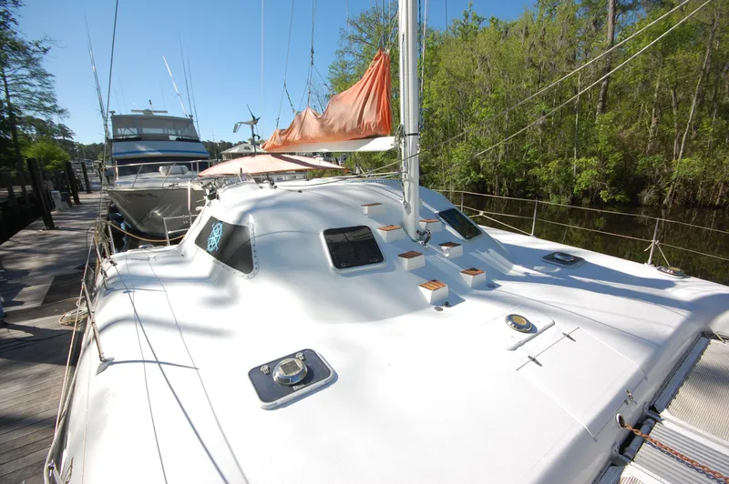 Slide: The Image of 1999 Wildcat 35 Catamaran docked, showcasing deck and sail. - 11