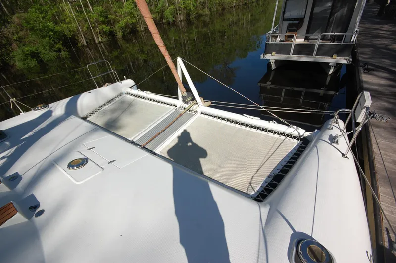 Slide: The Image of 1999 Wildcat 35 Catamaran deck with netting and docked at marina. - 13