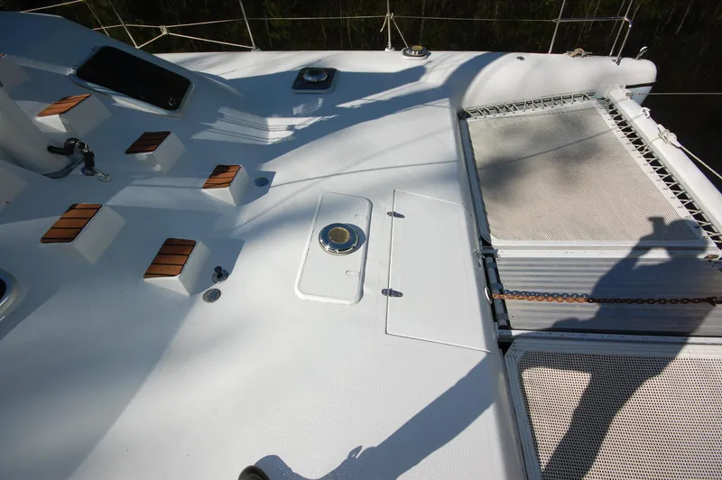 Slide: The Image of 1999 Wildcat 35 Catamaran deck with netting and wooden accents. - 14