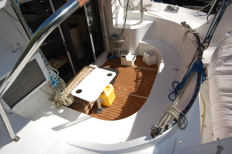 Slide: The Image of 1999 Wildcat 35 Catamaran deck with wooden flooring and seating area. - 19