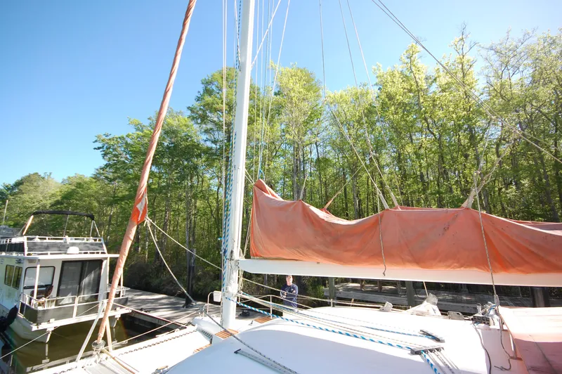 Slide: The Image of 1999 Wildcat 35 Catamaran docked near a forested area. - 20